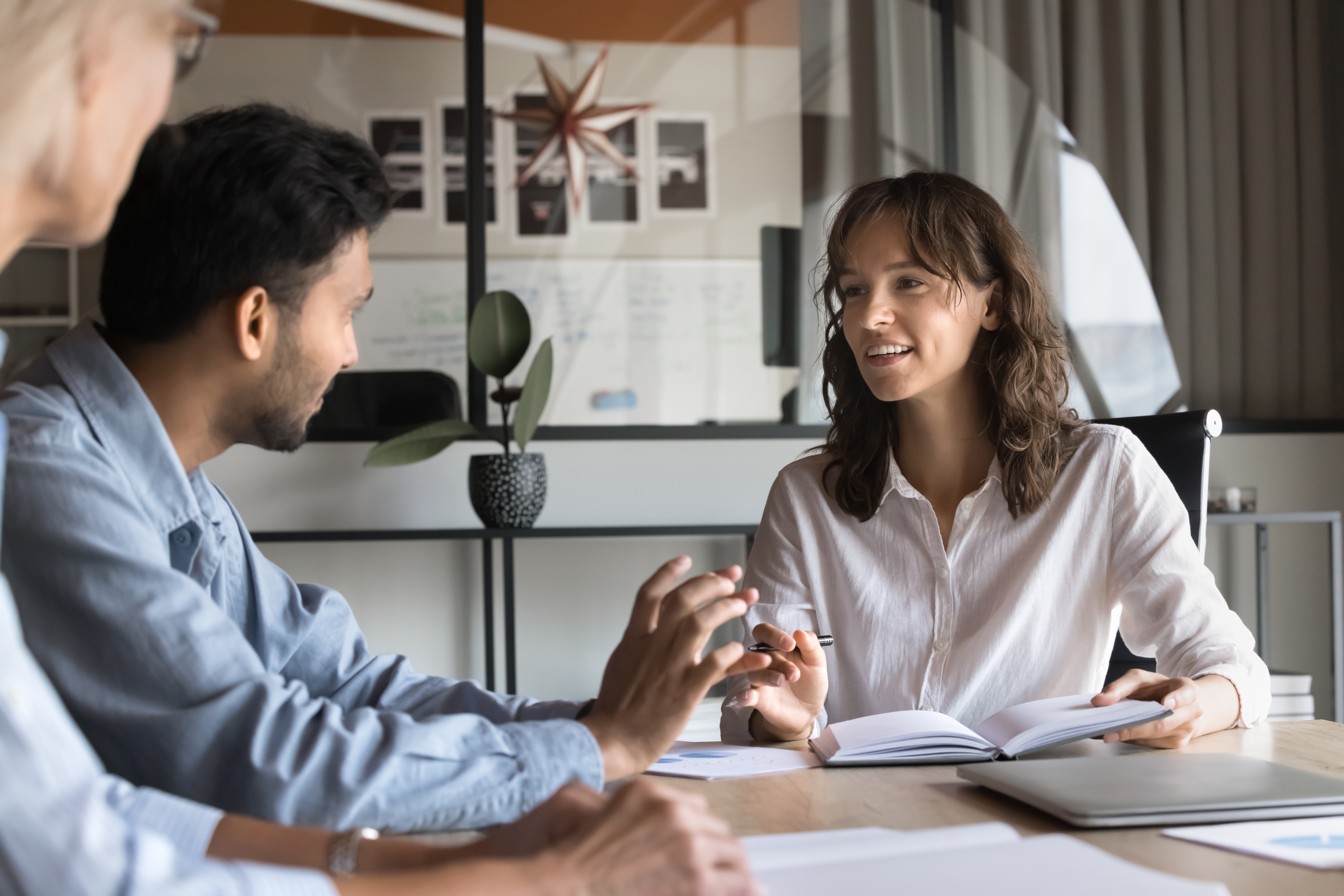A business professional collaborating with clients in the boardroom