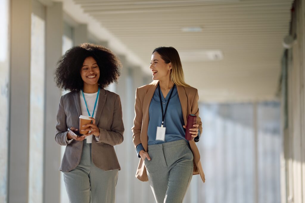 Young business professionals walking positively in the hallway of their office