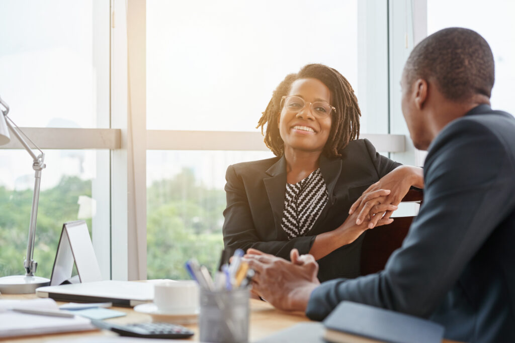 A young business professional chatting with his senior colleague.