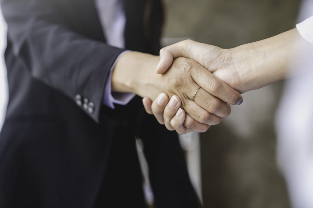 Two business professionals shaking hands
